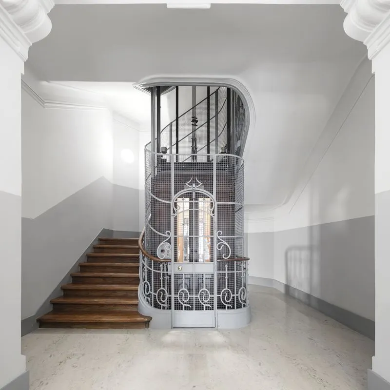 República 23 — restored Art Nouveau staircase and wrought-iron cage lift
